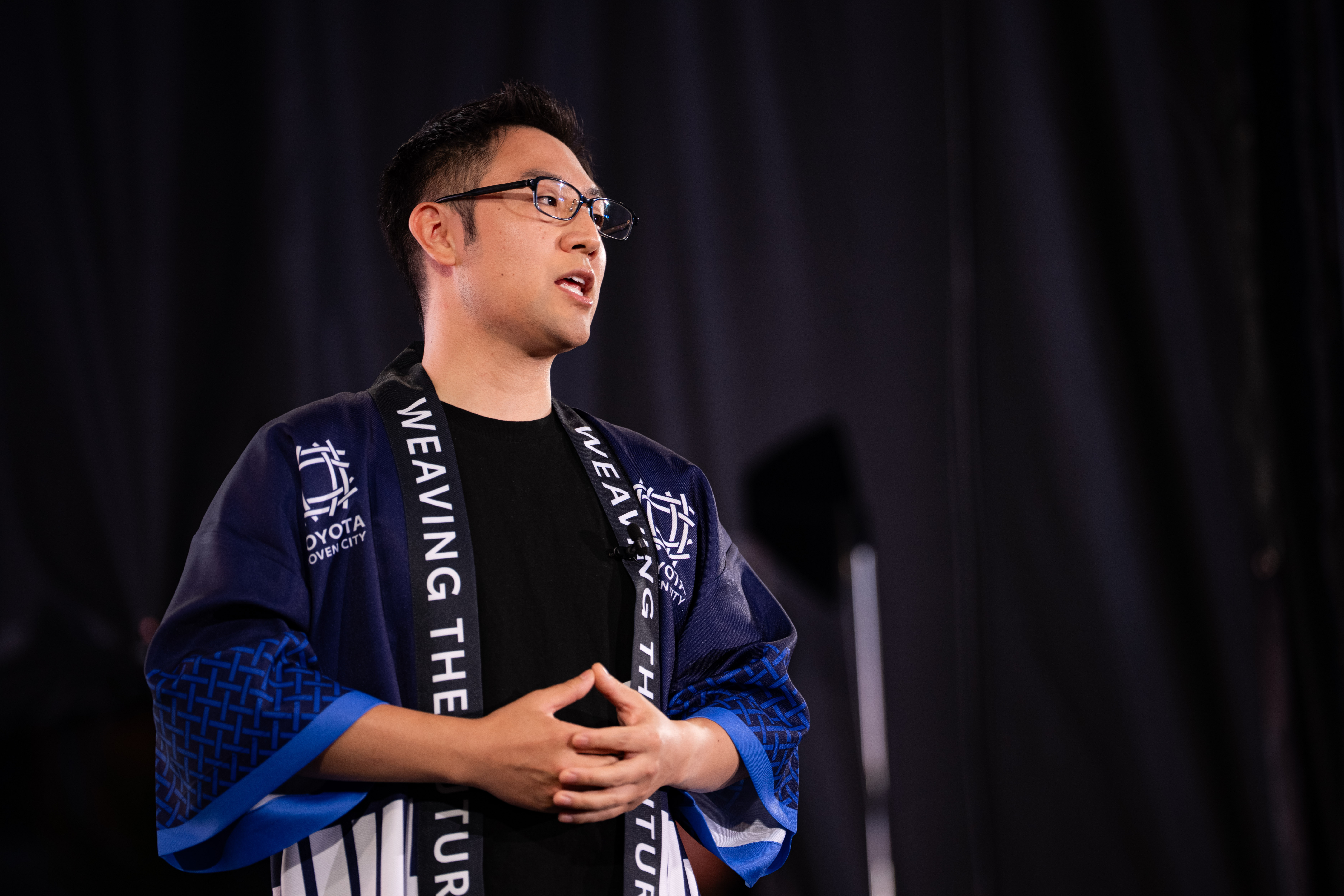 Daisuke Toyoda delivering a speech at Woven City's official launch event