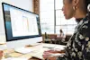 Woman sitting down looking at computer screen.