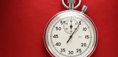 stopwatch on red background, how to improve OKRs