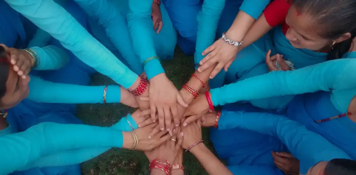 group of girls and women holding hands