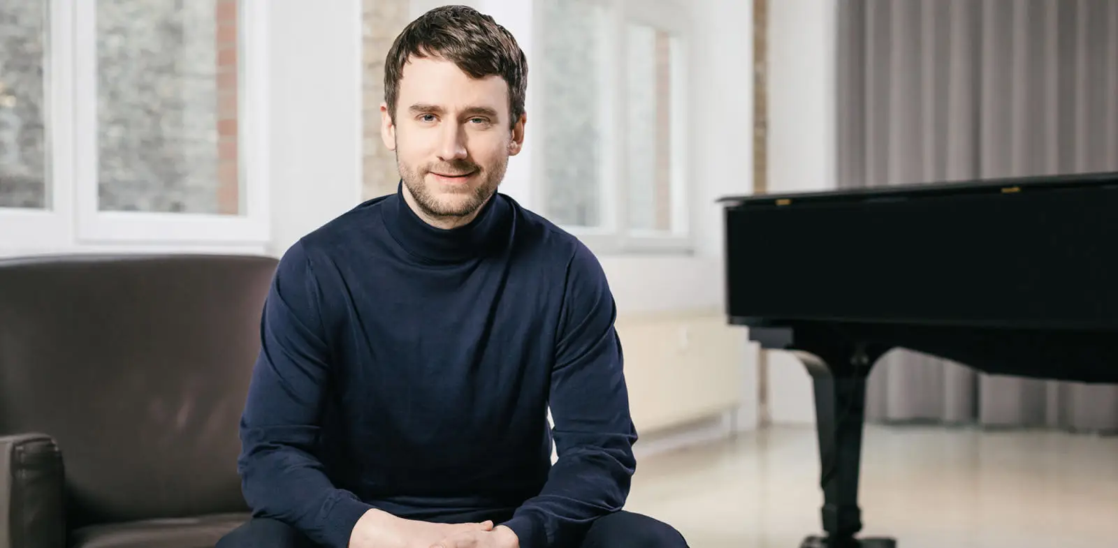 man sitting in front of a piano