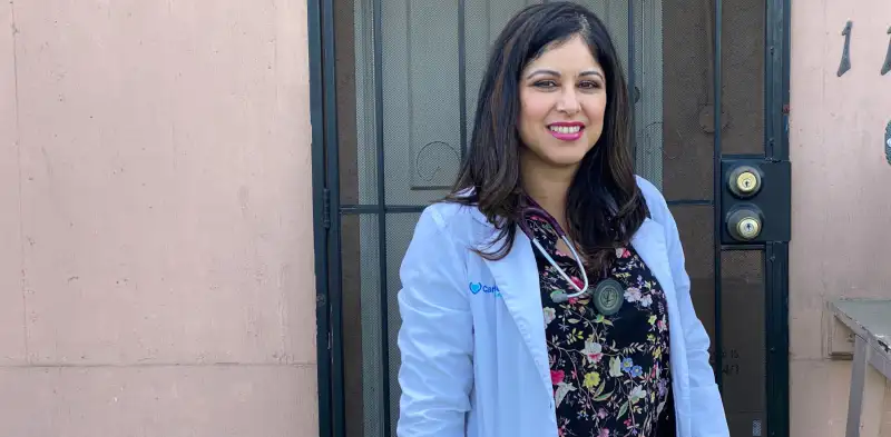 caremore doctor standing in front of screen door