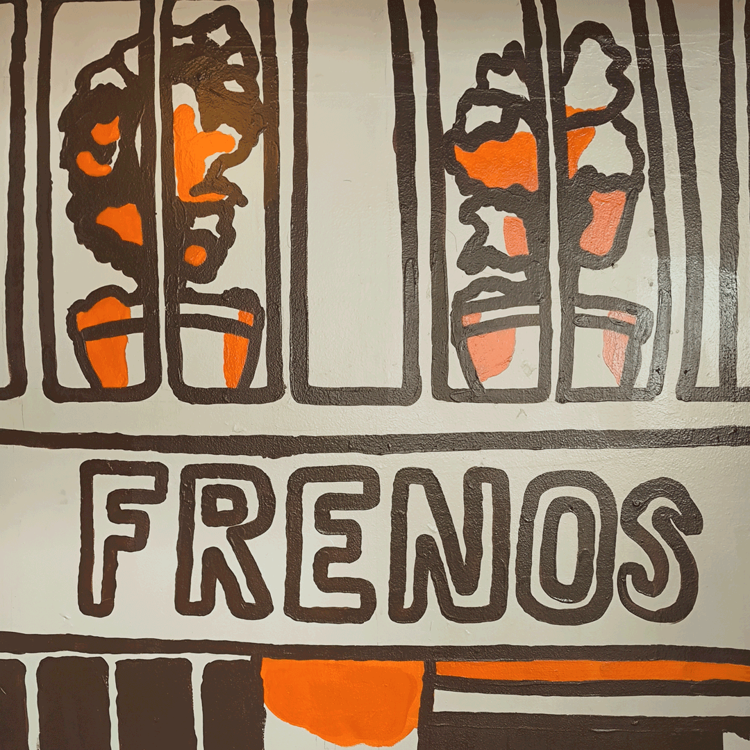 undefined undefined : A closer look at the hand-painted signage and the potted plants on the terrace above