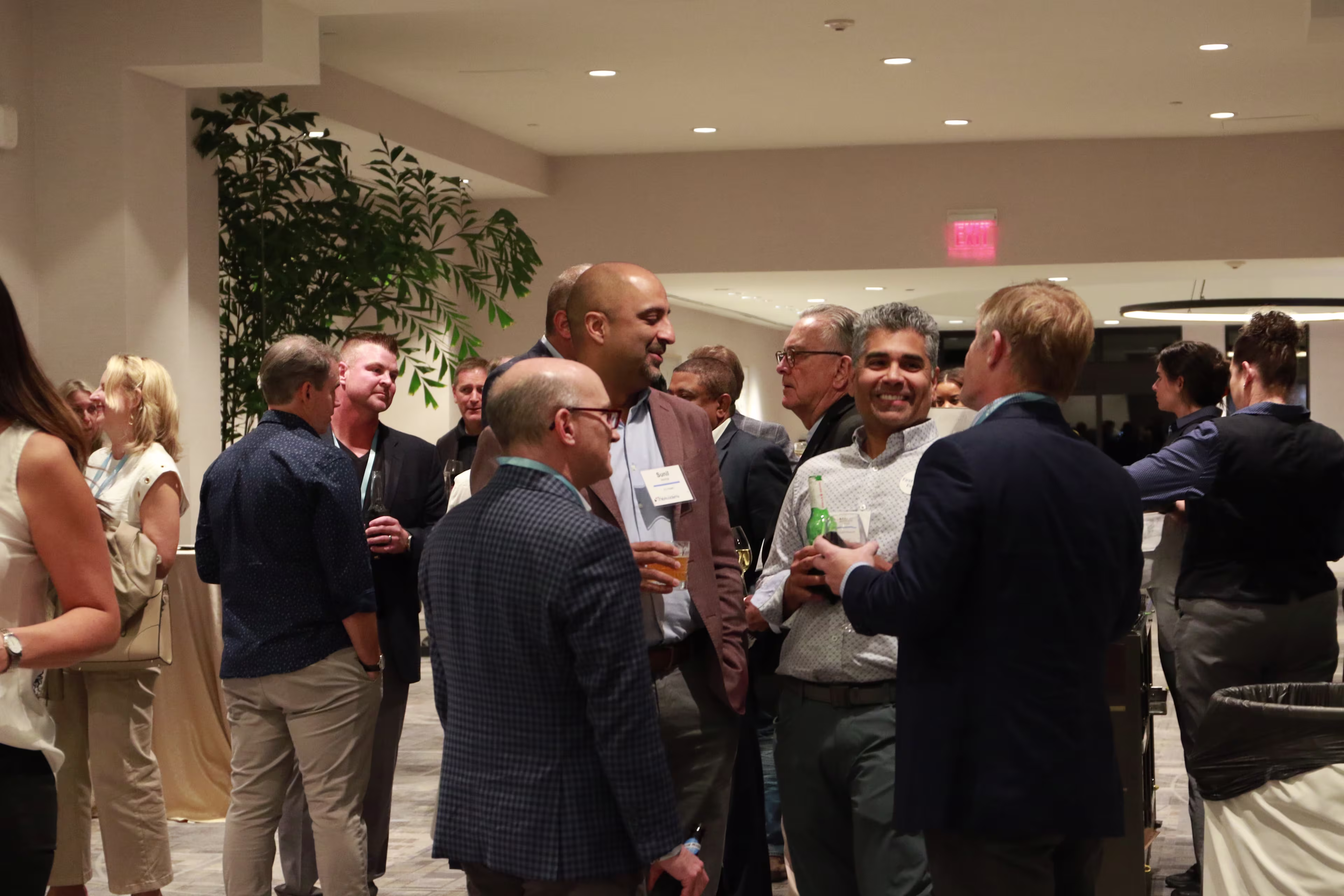 Executives conversing between sessions at a THMA healthcare conference