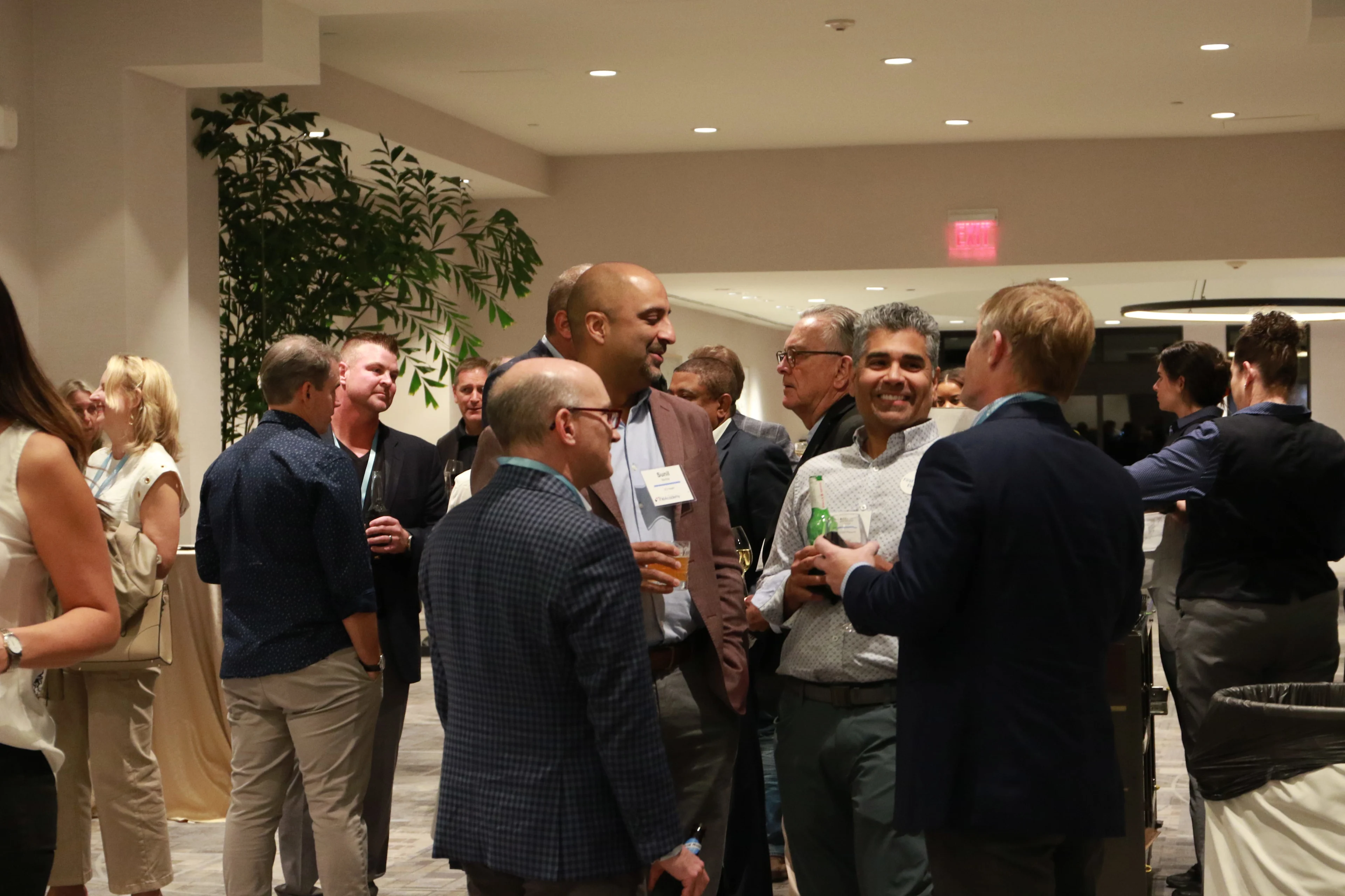 Executives conversing between sessions at a THMA healthcare conference