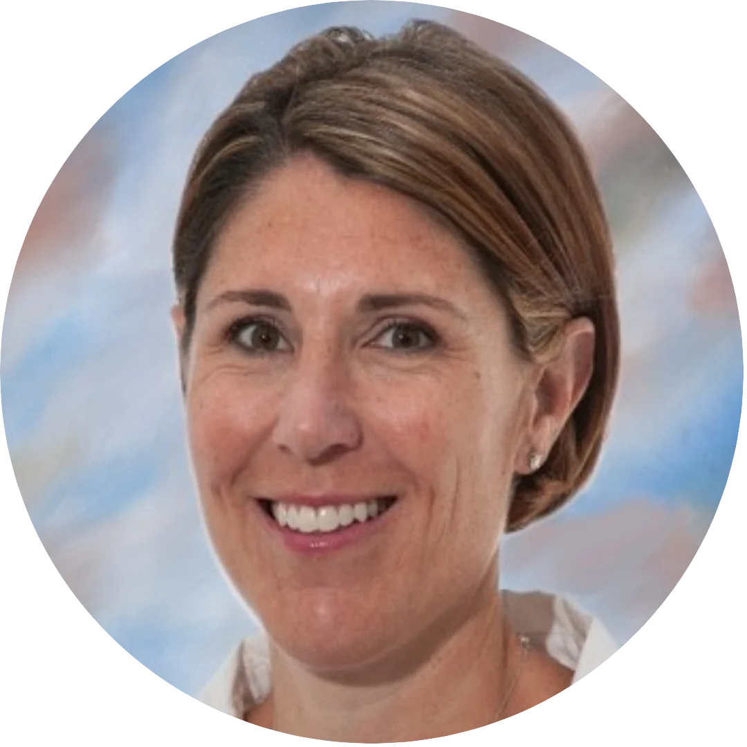 Smiling woman with neatly styled short brown hair wearing a white top, posed in front of a softly blurred pastel background.