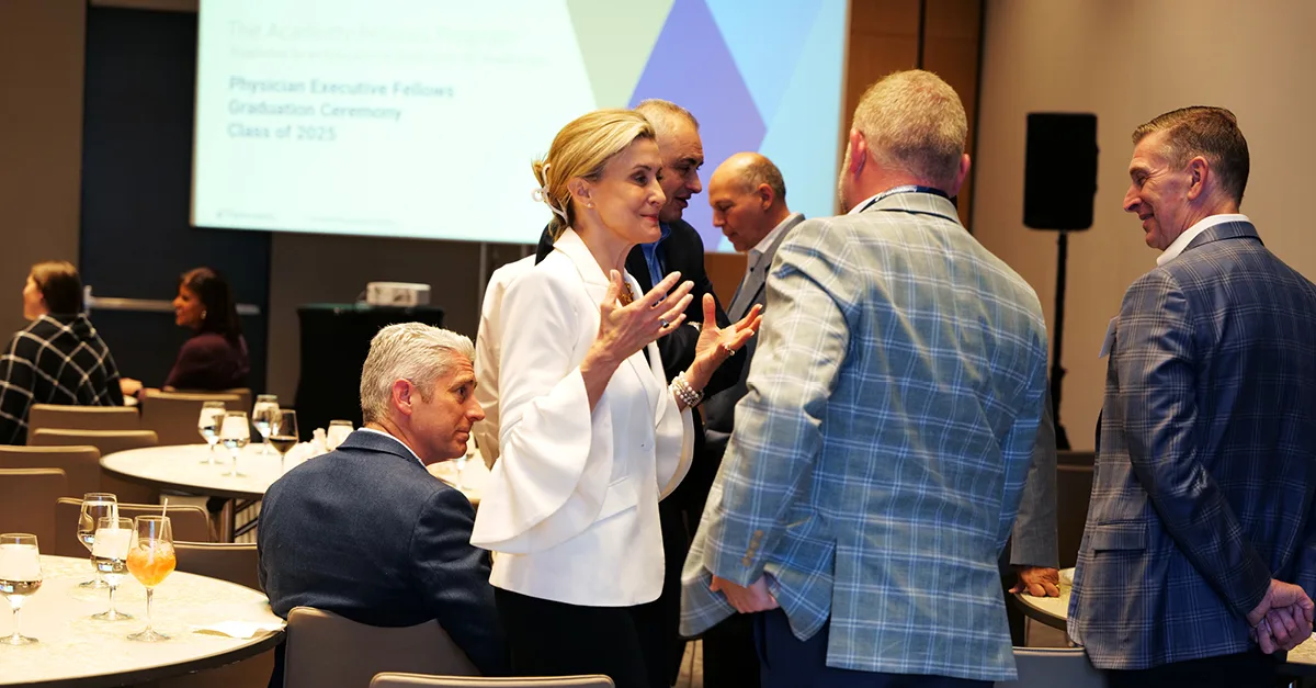 Healthcare leaders and a Chief Physician Executive participating in a networking session at The Academy’s Physician Executive Fellows graduation ceremony.