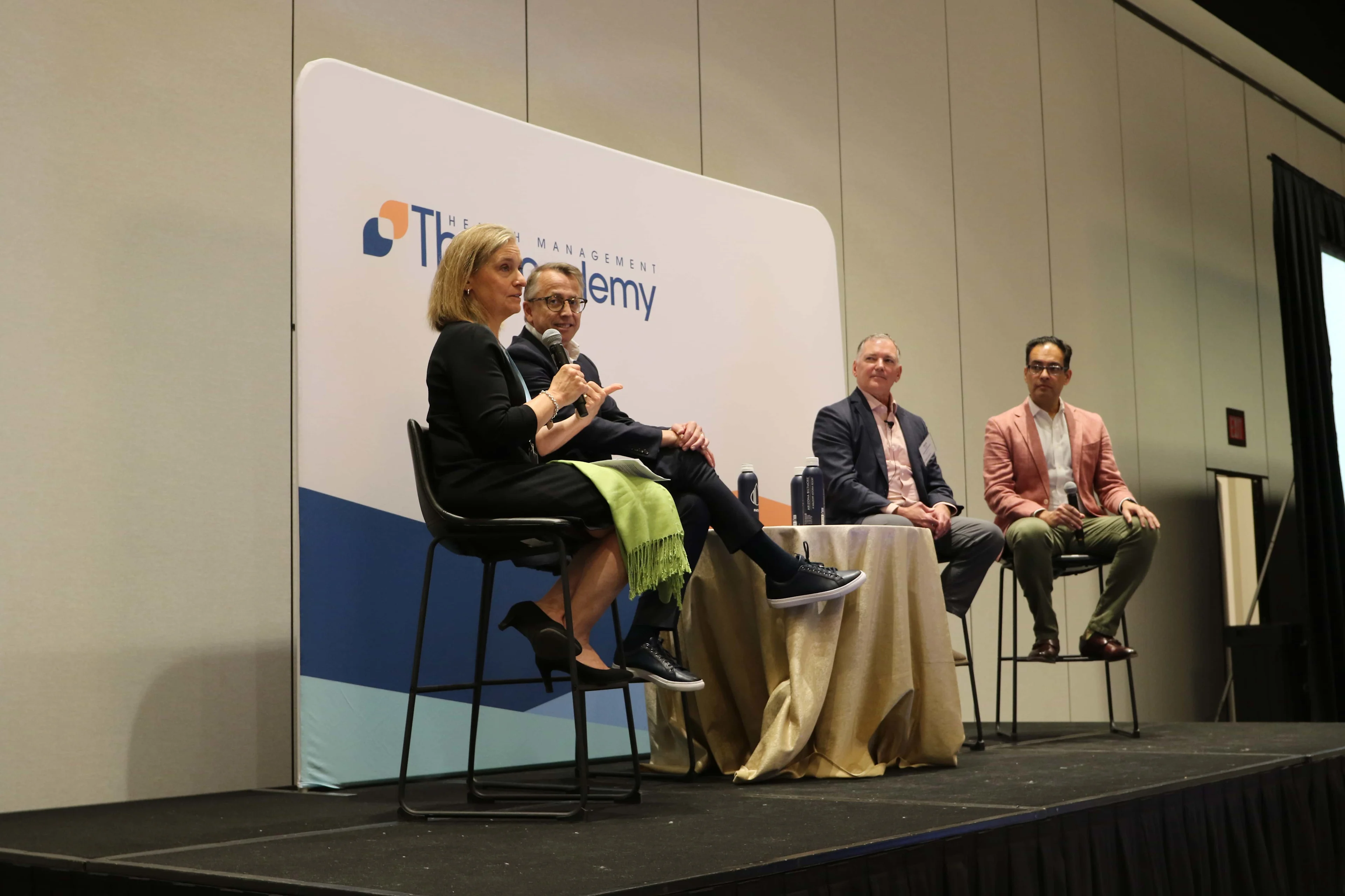 A diverse panel of healthcare executives and industry leaders sharing insights during a keynote session at a medical device conference.