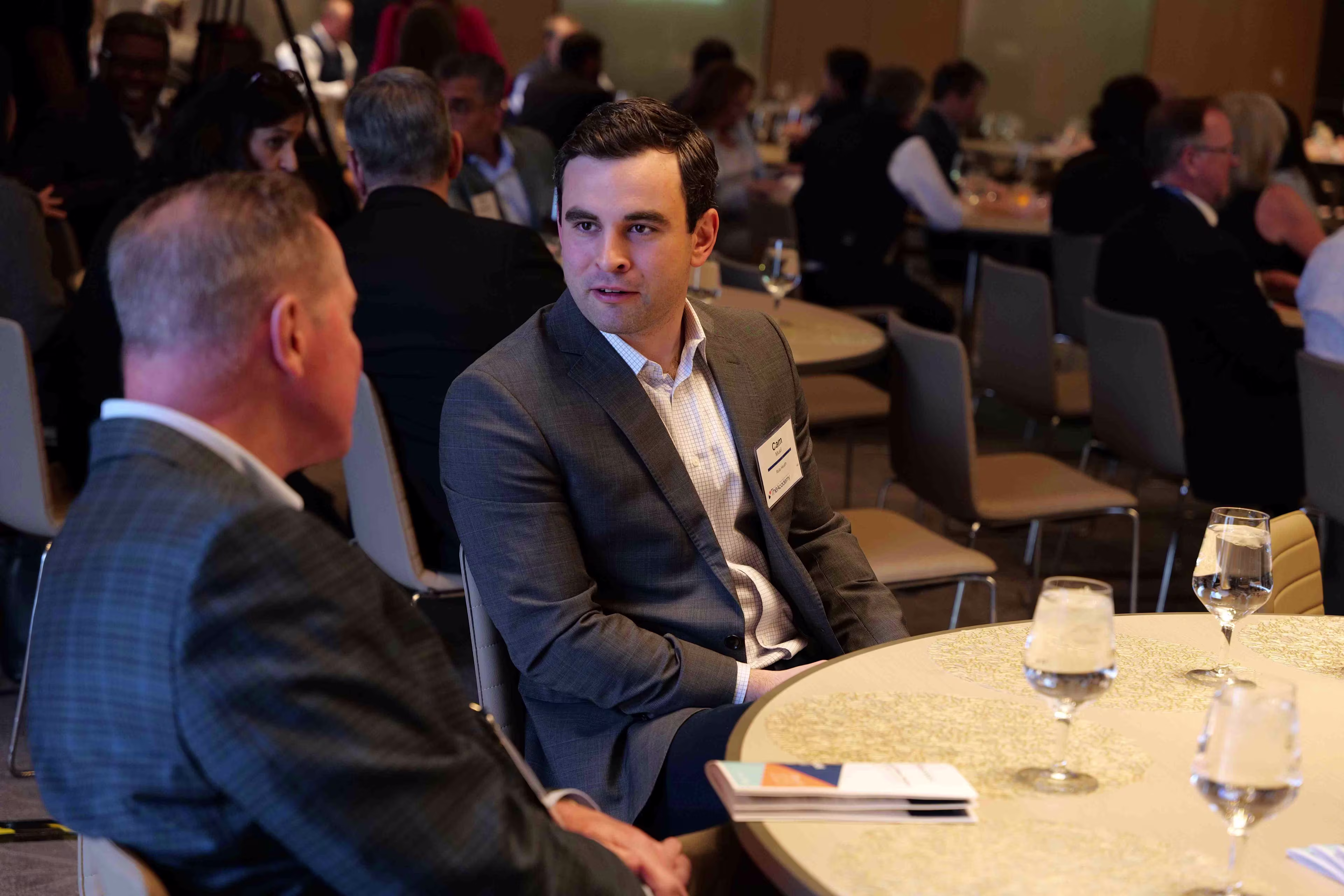Two healthcare executives share industry knowledge at a healthcare leadership event