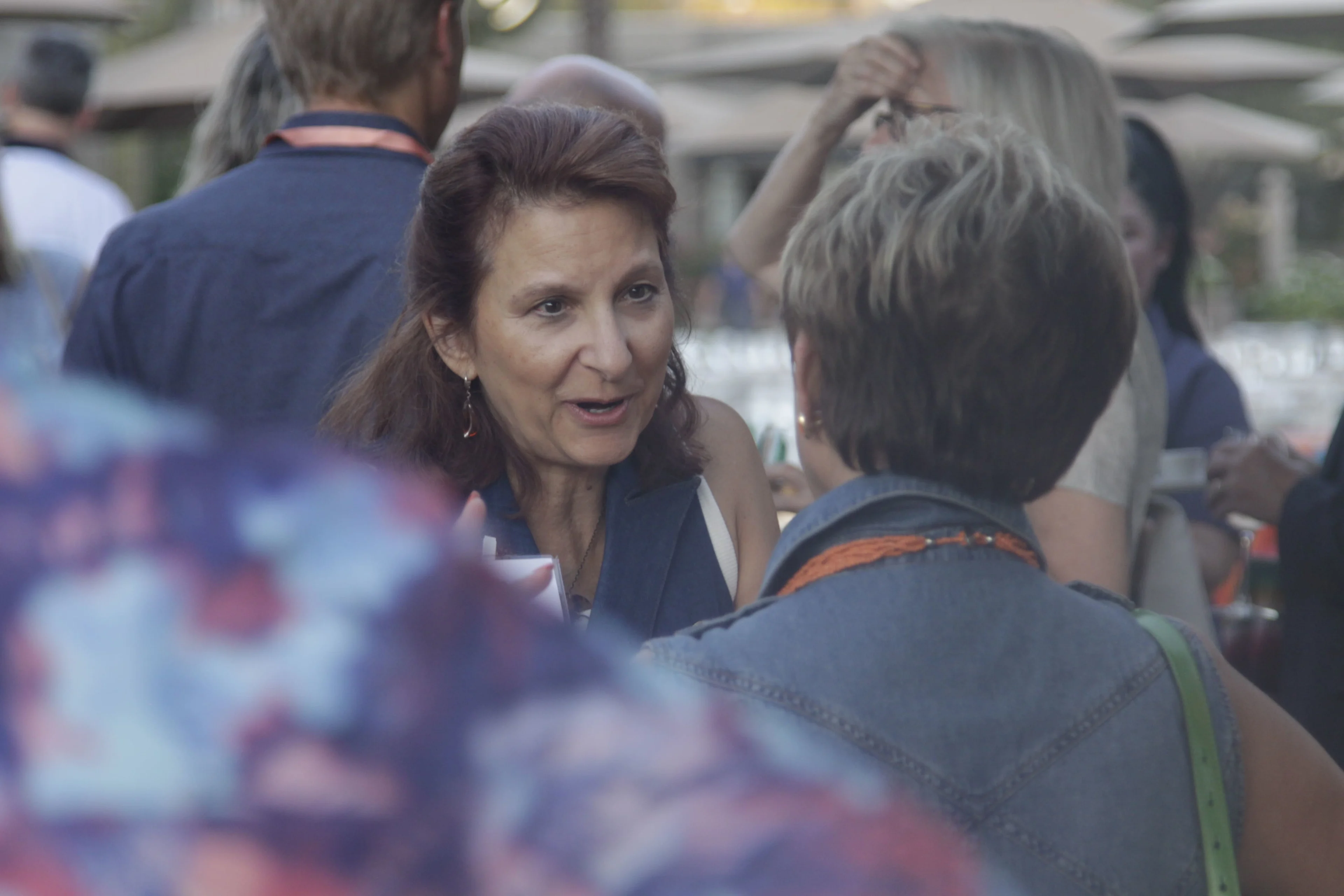 Two healthcare executives share a conversation at a healthcare legal conference