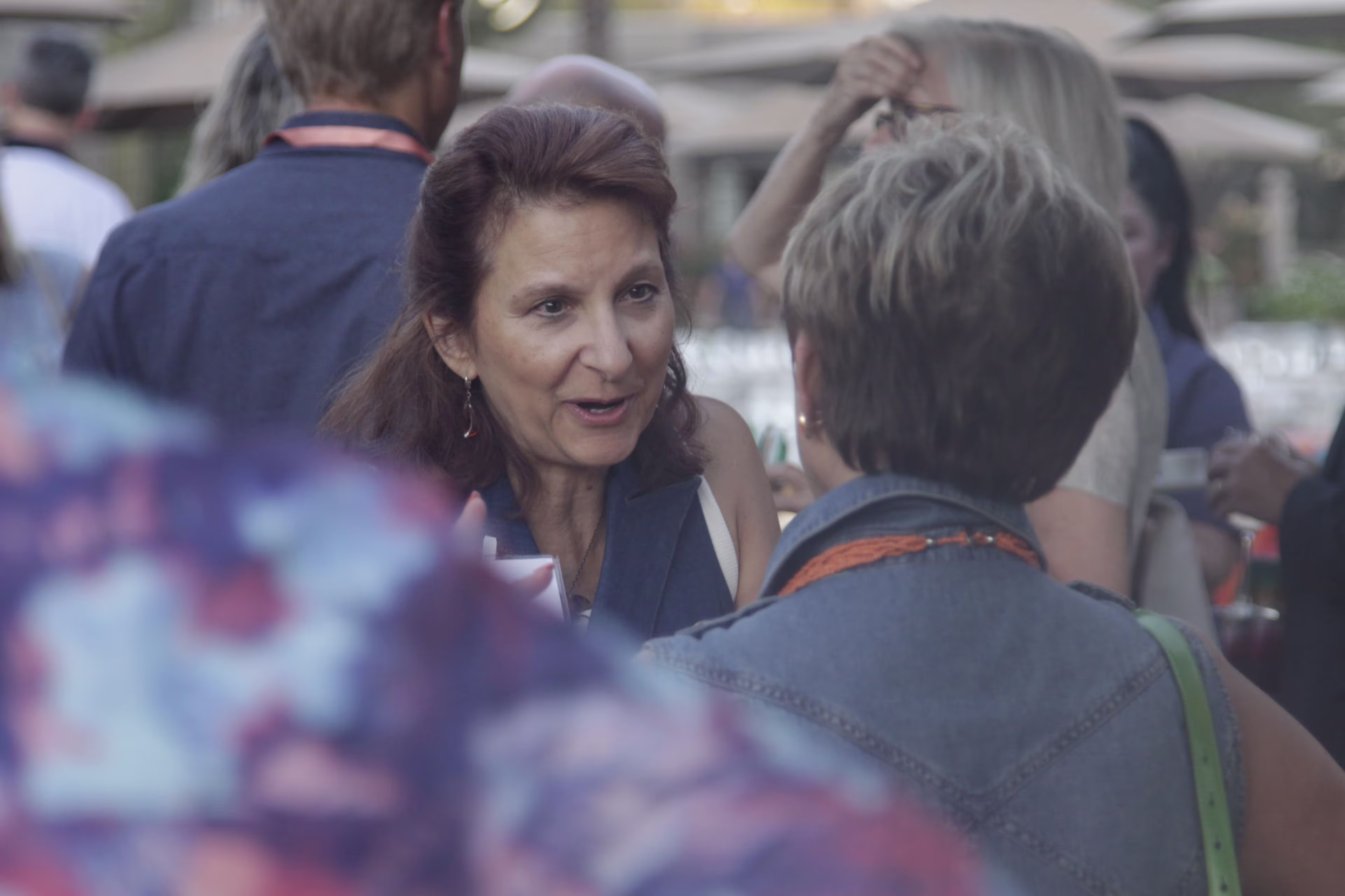 Two healthcare executives share a conversation at a healthcare legal conference