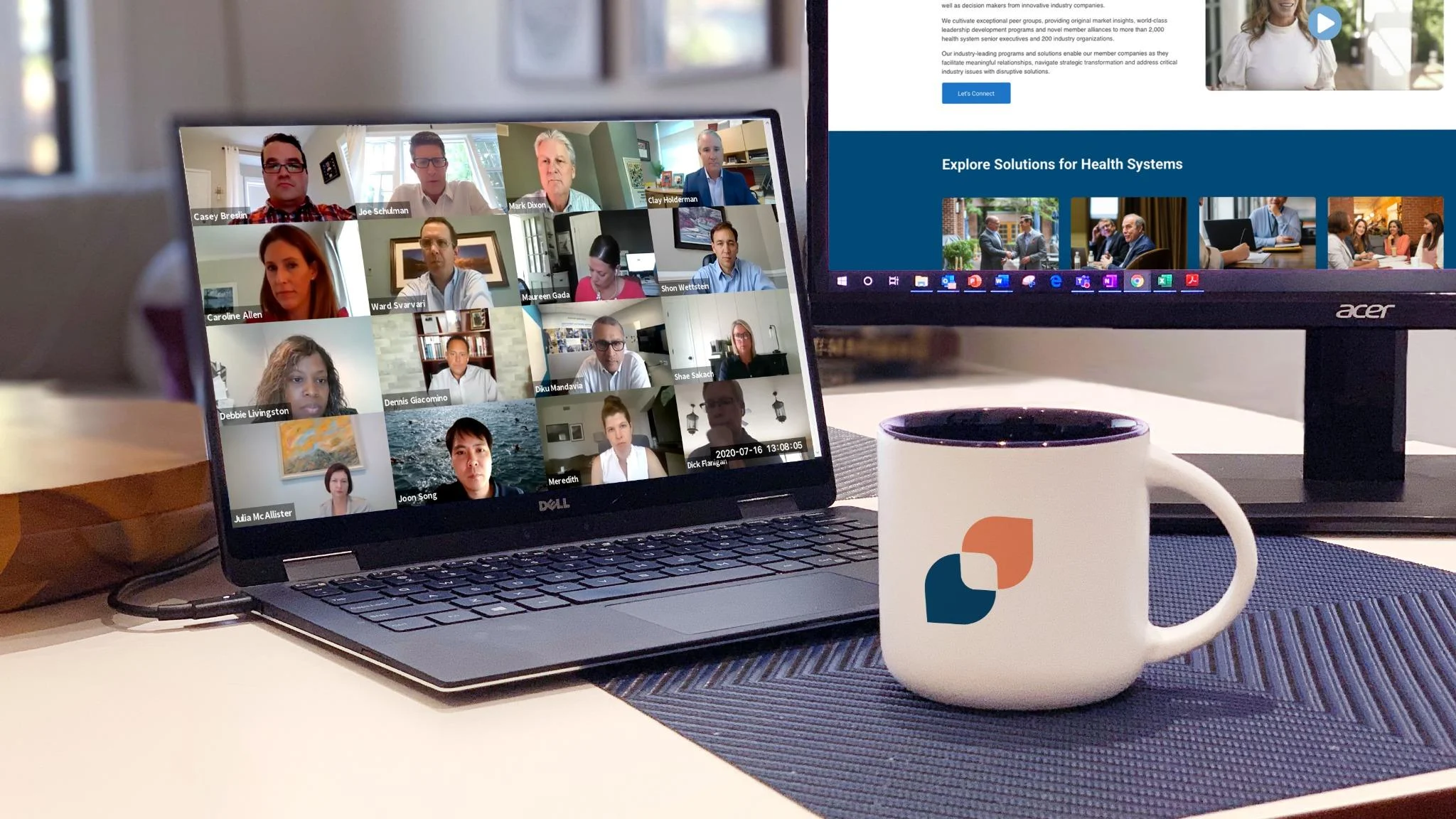 Two people collaborating at a desk with laptops and a document covered in notes.

