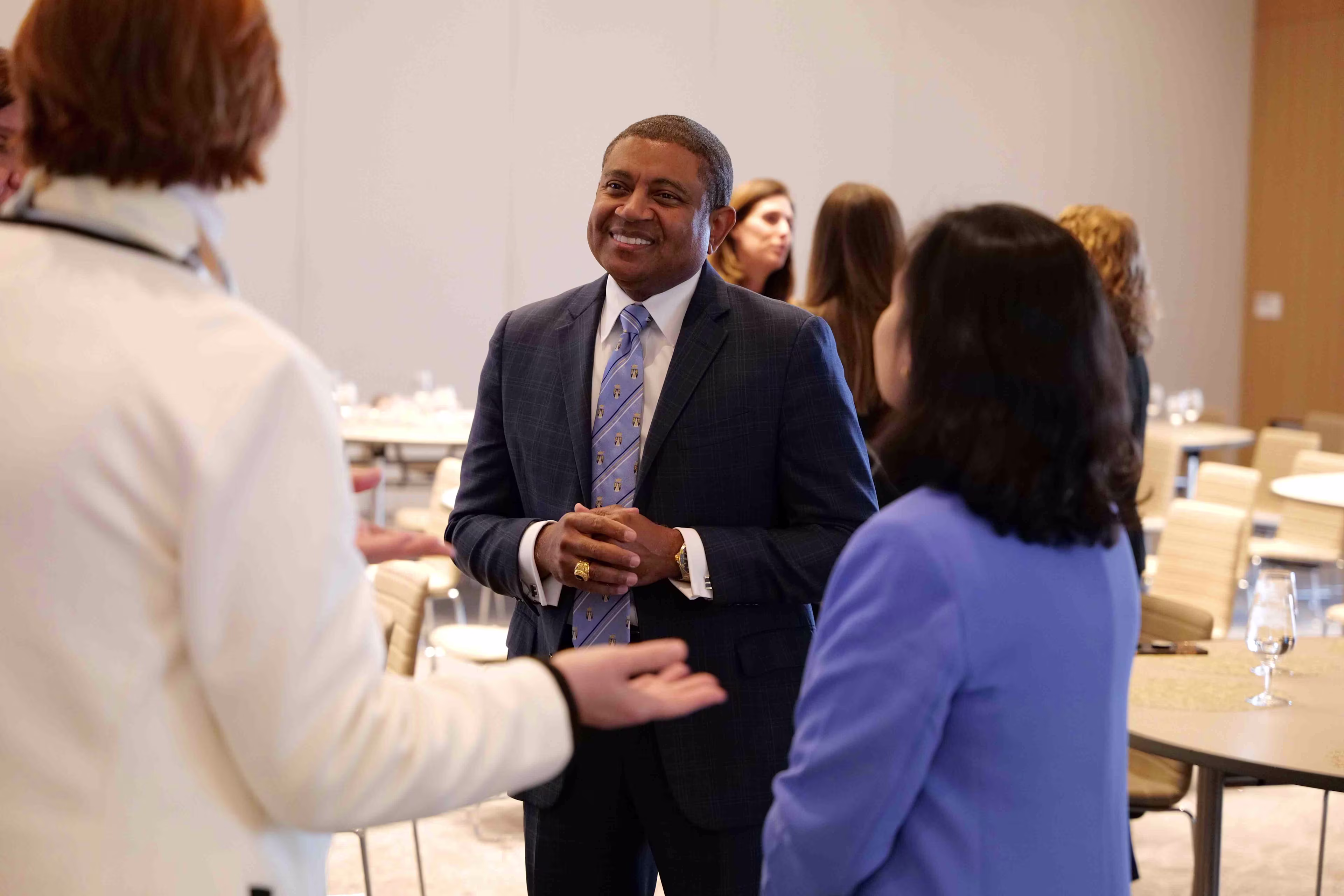 Executives conversing at a THMA healthcare leadership conference