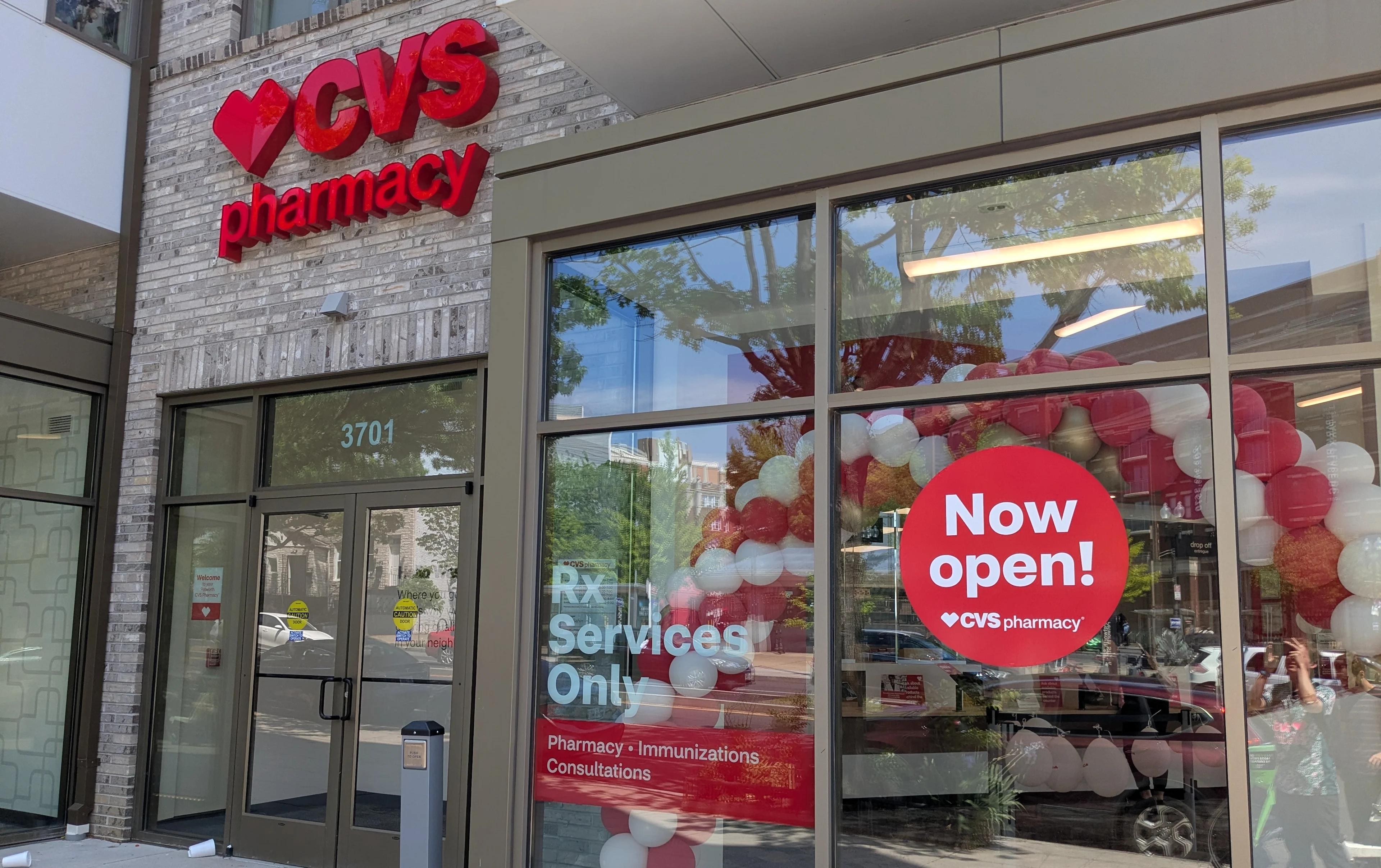 A photo of the outside of a new pharmacy-only CVS, with signage advertising the new store type.