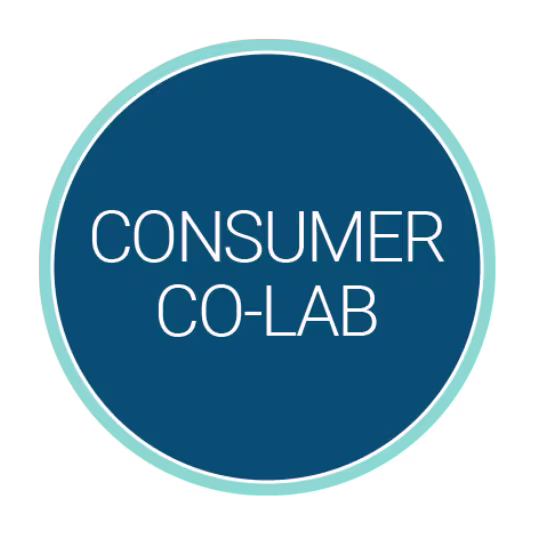 Circular blue logo with a light teal border containing the white title “Consumer Co-Lab” centered inside.