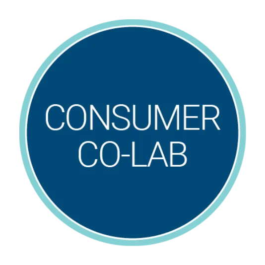 Circular blue logo with a light teal border containing the white title “Consumer Co-Lab” centered inside.