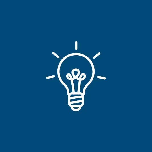 Dark blue icon image of a light bulb.