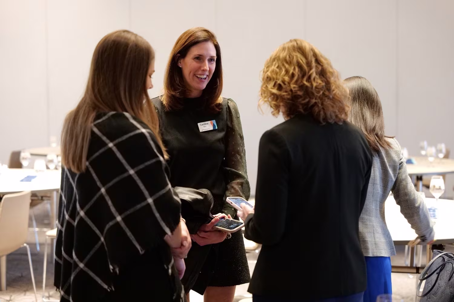 Healthcare CEOs exchanging insights during a private discussion at the healthcare CEO conference.