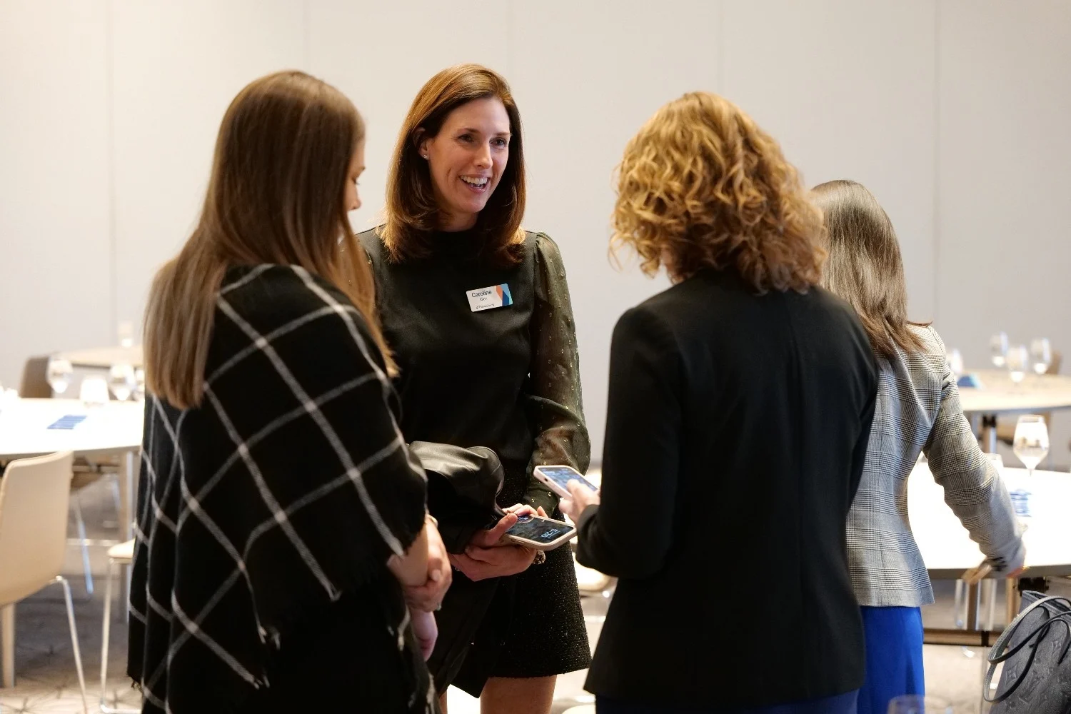 Healthcare CEOs exchanging insights during a private discussion at the healthcare CEO conference.