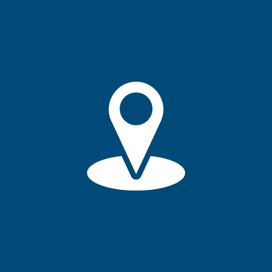 A white location pin icon centered above an oval base, representing a marked place or destination.