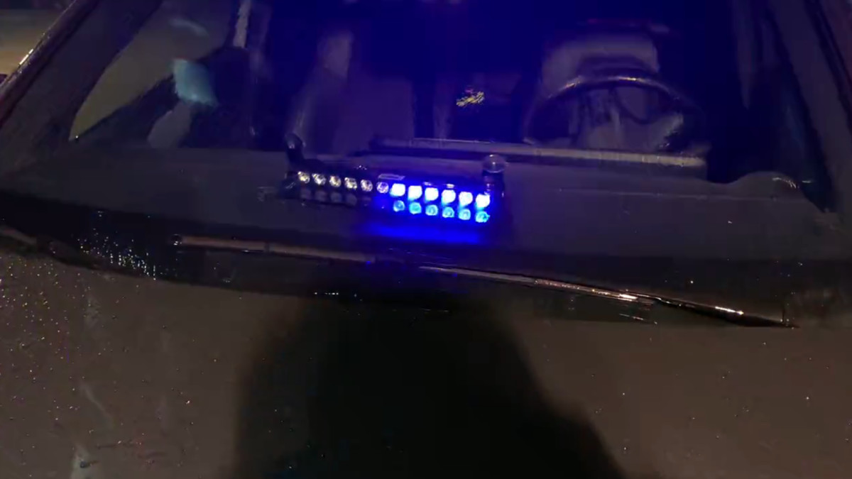 De auto met achter de voorruit de blauwe flitslamp