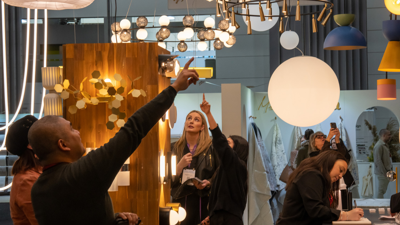 People pointing up towards various light fixtures. 