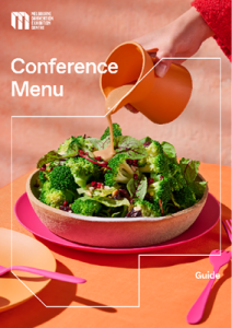 Cover image of the MCEC conference menu. A bright green salad is on the front with a hand pouring a dressing from an orange jug on top of the salad. 