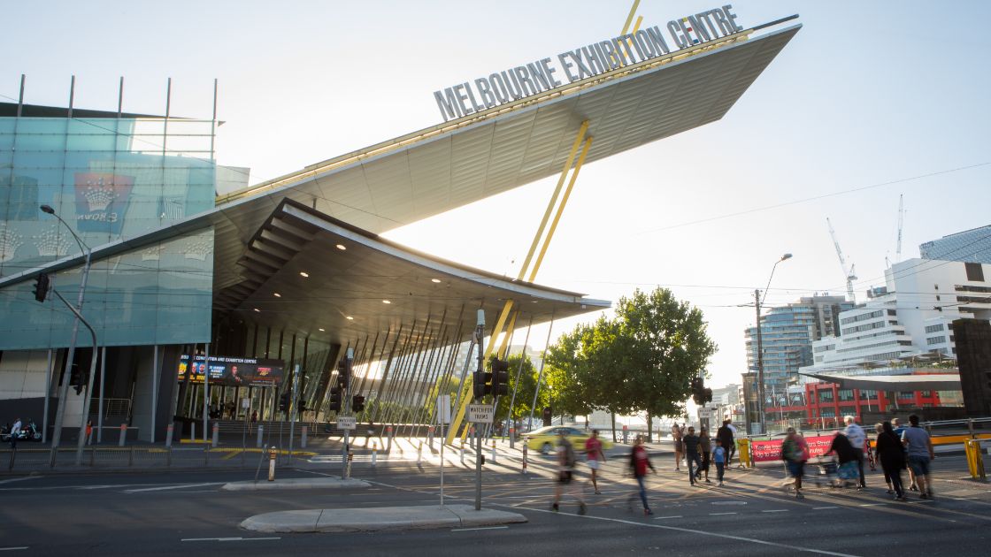 Bicyclists and pedestrians crossing the road towards MCEC. 