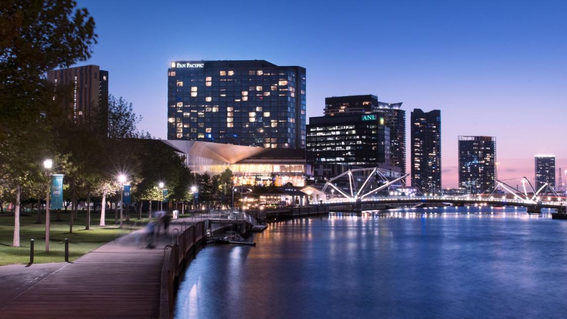 Outside view of the Pan Pacific Melbourne Hotel at dusk. 