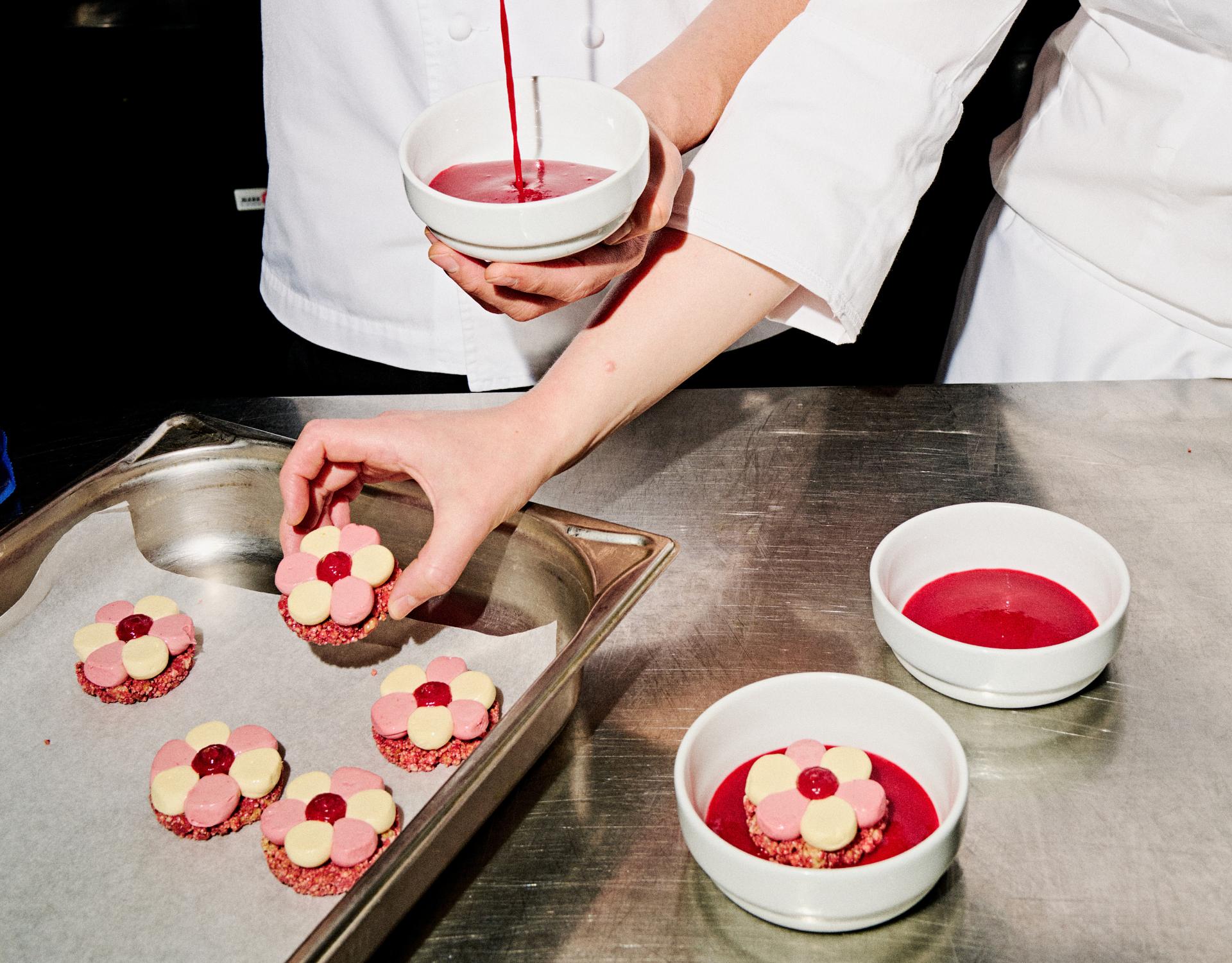 Pastry chefs at MCEC preparing a pink, red and white dessert.