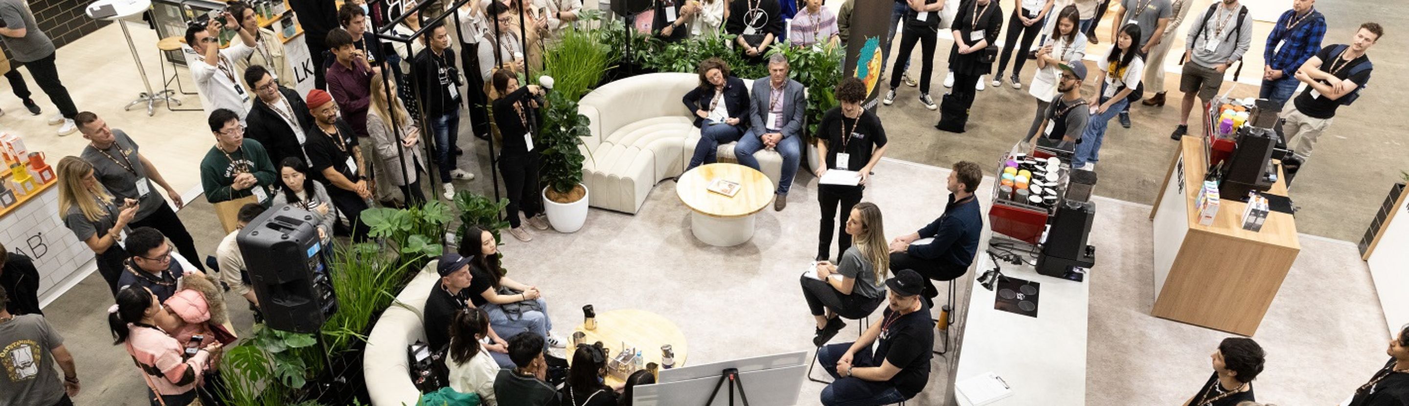 Crowd of people watching a presentation at the Melbourne International Coffee Expo.