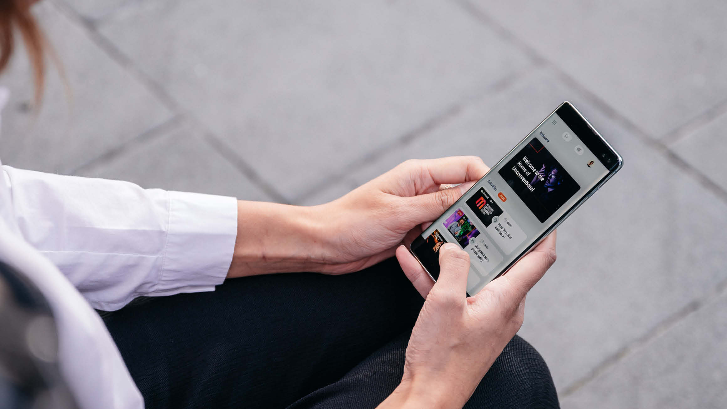 A close-up image featuring a person holding a sleek and modern mobile phone. 