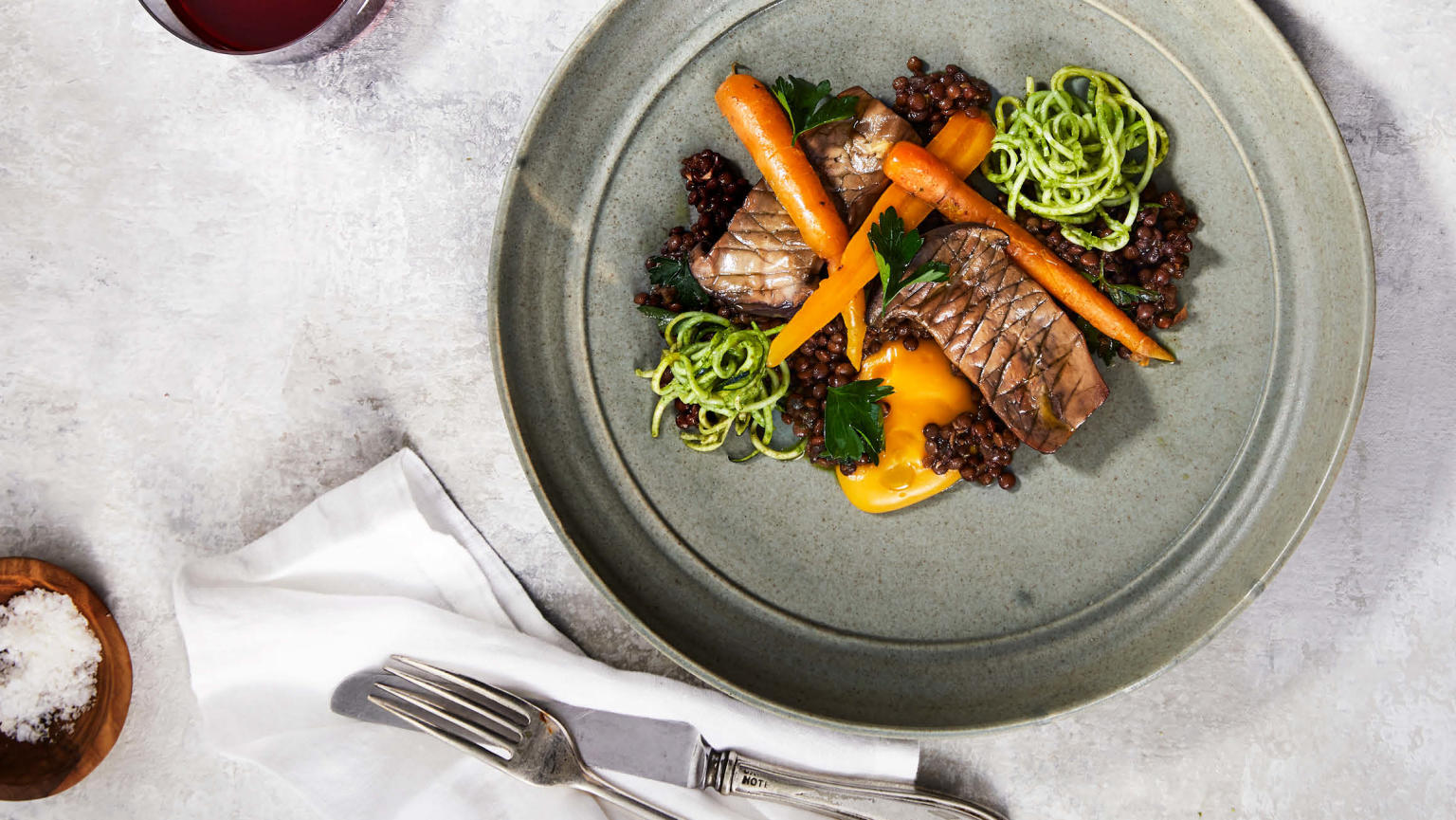 Bird's eye view of a delicious steak and vegetable dish presented on a table.