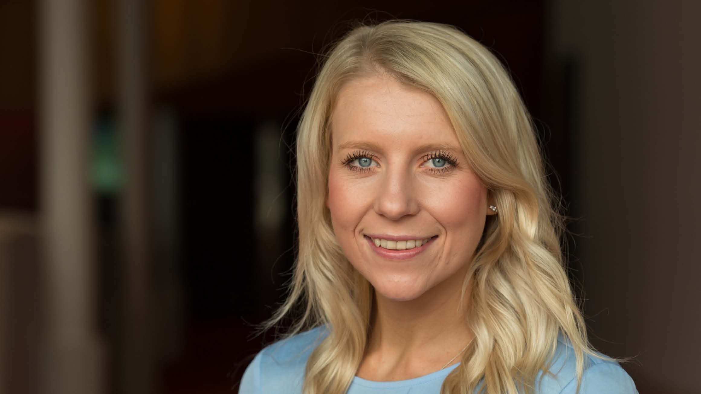 Headshot of blonde woman smiling. 