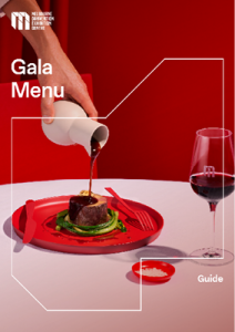 Cover image of the MCEC gala menu. A hand pours a liquid onto a large piece of meat, presented on a red plate. 