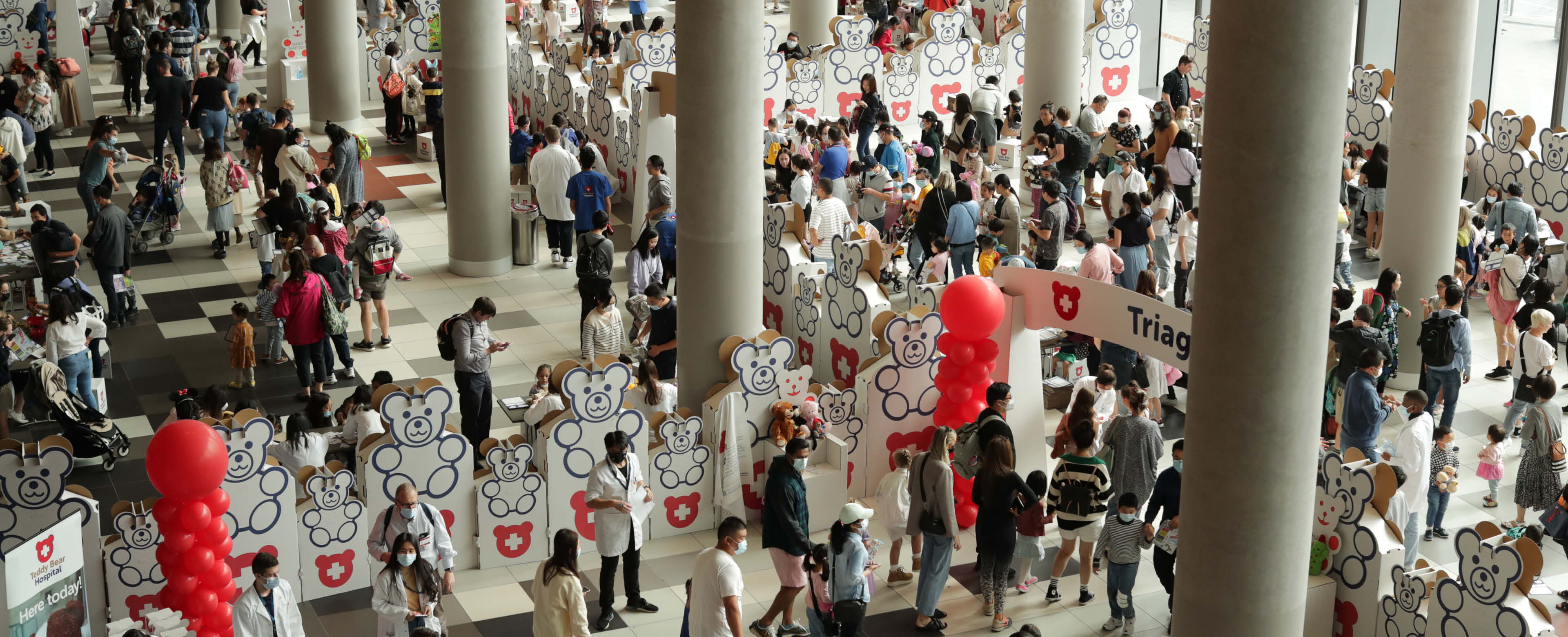 Over head view of the Teddy Bear Hospital at the Good Friday Appeal filled with people in the Convention Centre foyer at MCEC. 