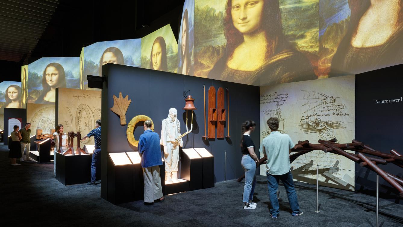 A small group of people wander around THE LUME Melbourne Leonardo da Vinci - 500 Years of Genius gallery. 