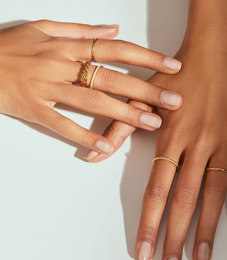 woman wearing multiple gold rings
