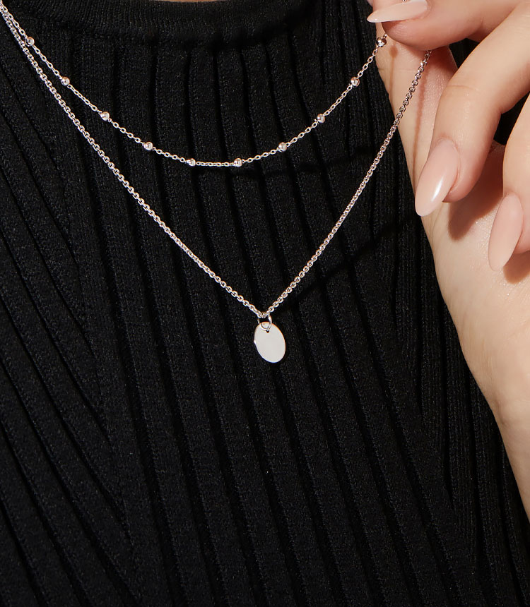 a layered pearl necklace on a black background