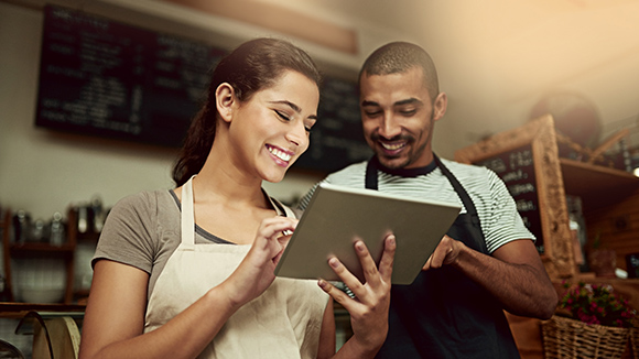 man and woman looking at tablet