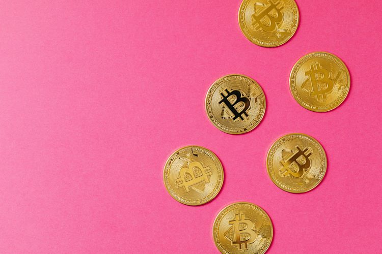 Bitcoin coins on pink bacground