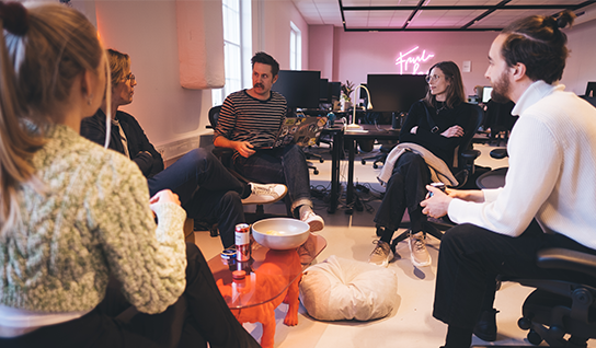 four people in a discussion at the office