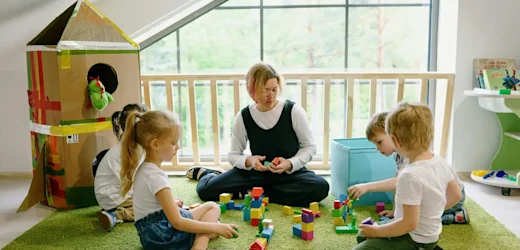 Early childhood education student gaining hands-on experience during a work placement, engaging with children in a learning environment.