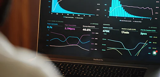 website page data and insights on a Macbook Pro screen being analysed by a data analyst