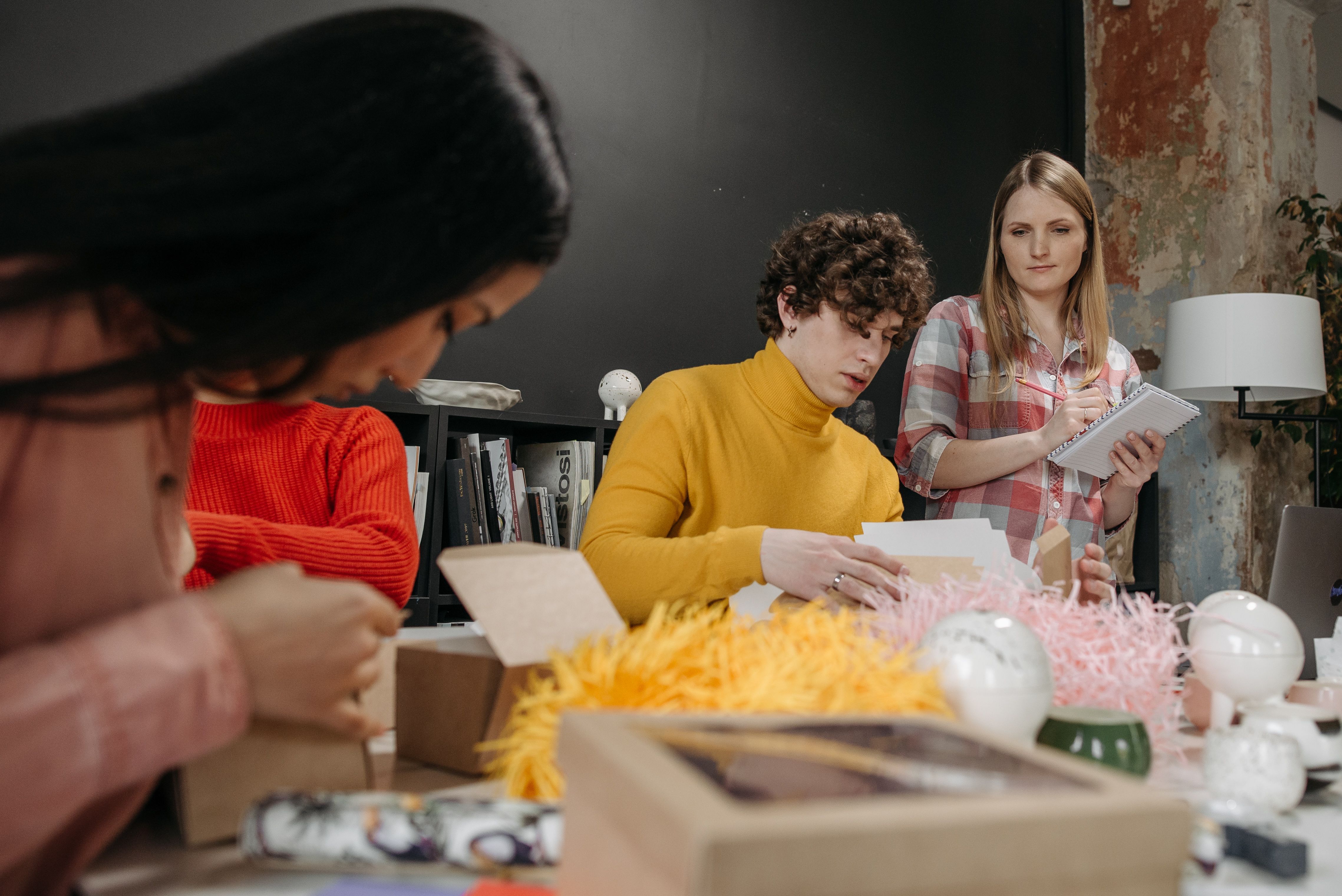 A team in a fun job with good pay working together on a creative project in an office.