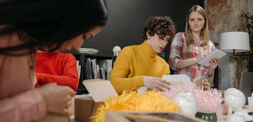A team in a fun job with good pay working together on a creative project in an office.