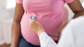 Pregnant person having their blood pressure checked