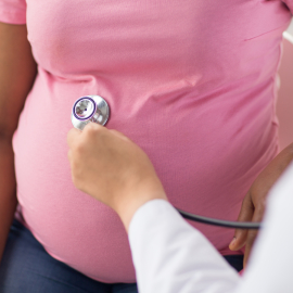 Pregnant person having their blood pressure checked