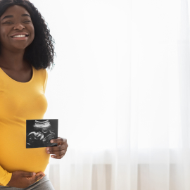 Pregnant woman with ultrasound picture