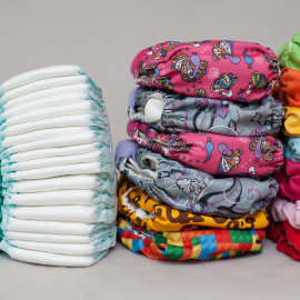 Image of two stacks of disposable diapers and two stacks of cloth diapers